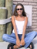 Slim Playful Girl Lori Anderson In Blue Jeans And White Top Plays With Her Arm Hair In The Sun