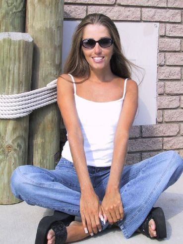 Slim Playful Girl Lori Anderson In Blue Jeans And White Top Plays With Her Arm Hair In The Sun